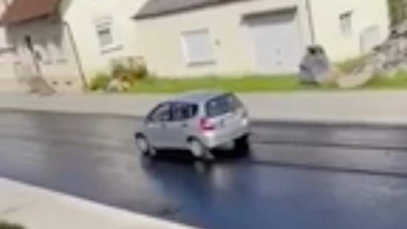 Automobilista molto distratta: passa con l’auto sull’asfalto ma... è fresco VIDEO